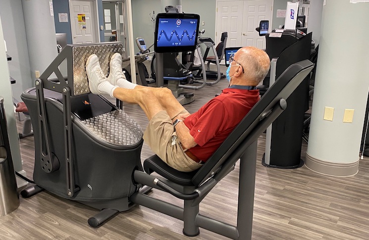 Older man working out on EGYM Smart Strength machine